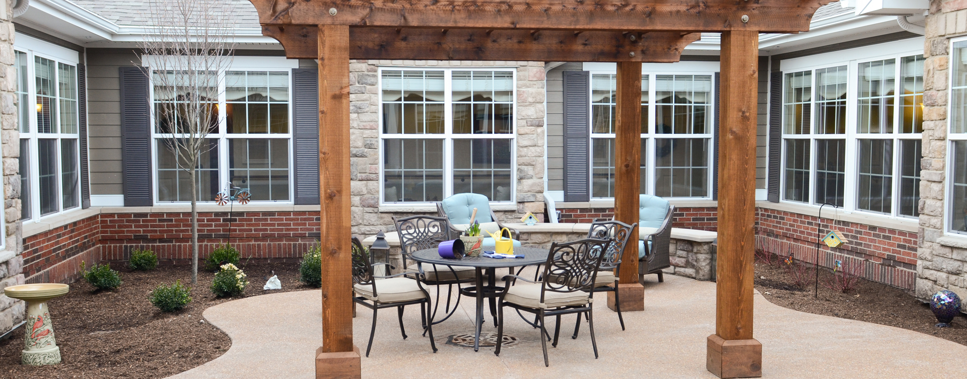 Residents with dementia can enjoy a traveling path, relaxed seating and raised garden beds in the courtyard at Bickford of Aurora