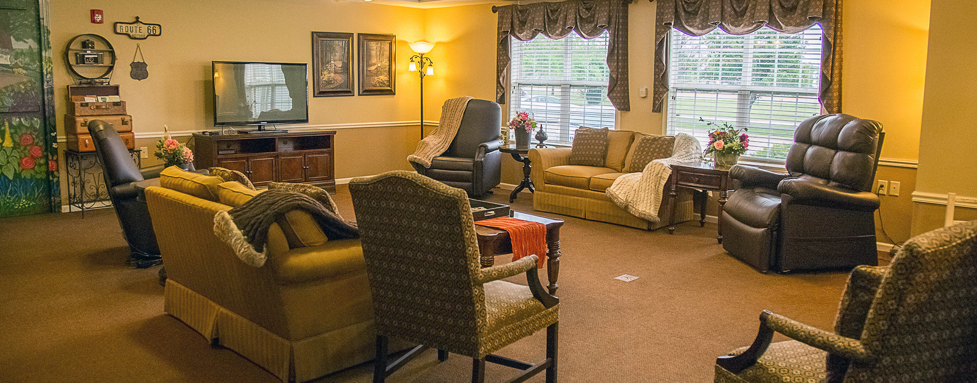 Residents can enjoy furniture covered in cozy fabrics in the Mary B’s living room at Bickford of Burlington