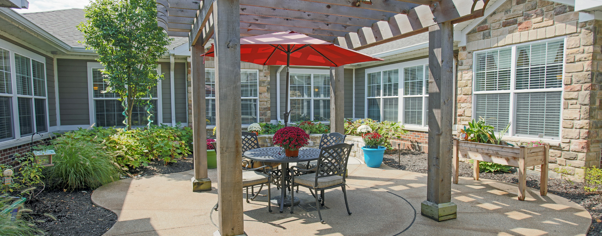 Residents with dementia can enjoy a traveling path, relaxed seating and raised garden beds in the courtyard at Bickford of Carmel