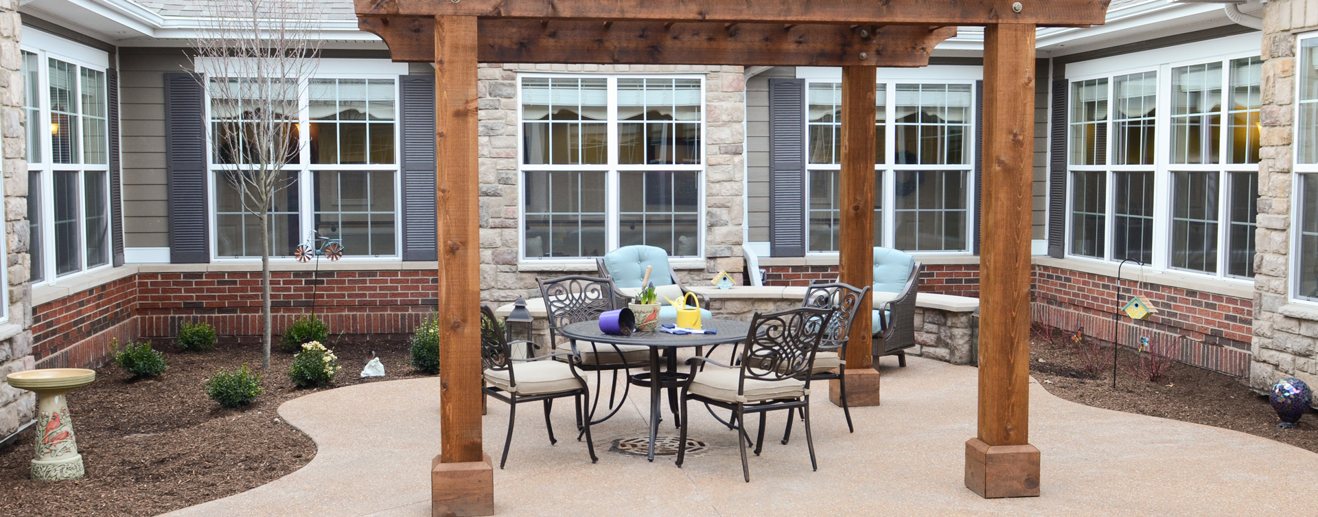 Residents with dementia can enjoy a traveling path, relaxed seating and raised garden beds in the courtyard at Bickford of Gurnee