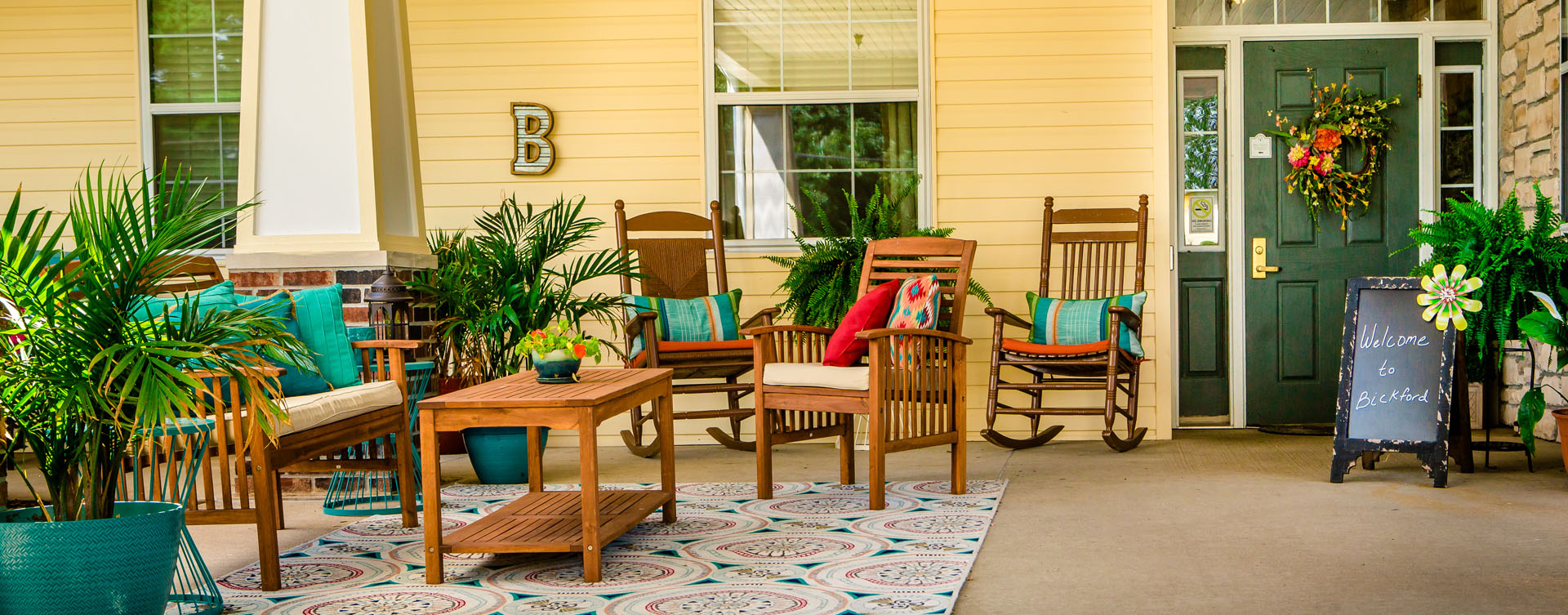 Enjoy conversations with friends on the porch at Bickford of Macomb