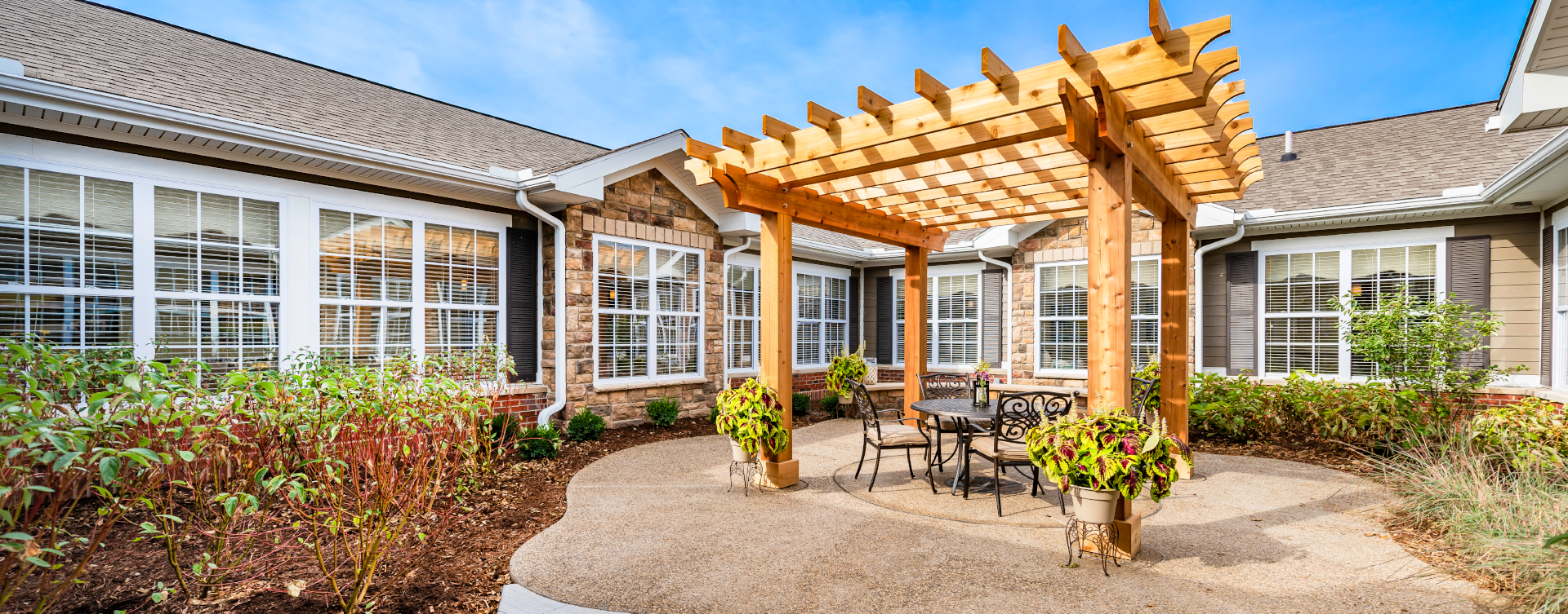 Residents with dementia can enjoy a traveling path, relaxed seating and raised garden beds in the courtyard at Bickford of Shelby Township