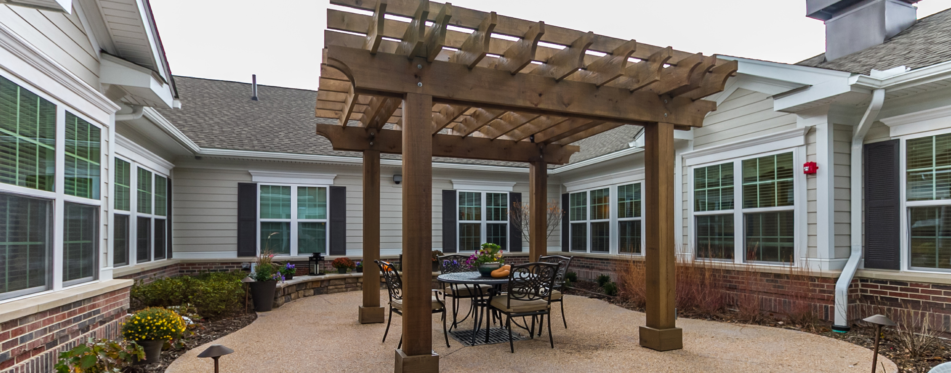 Residents with dementia can enjoy a traveling path, relaxed seating and raised garden beds in the courtyard at Bickford of Virginia Beach